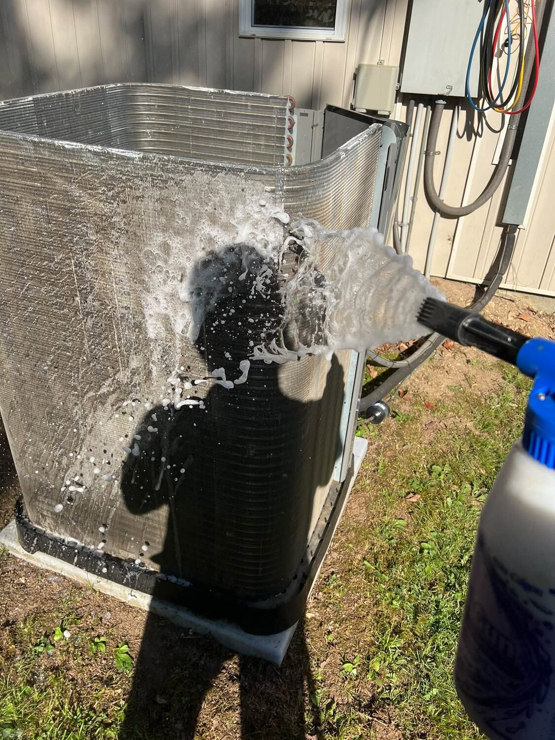 Rinsing the AC condenser coil with water