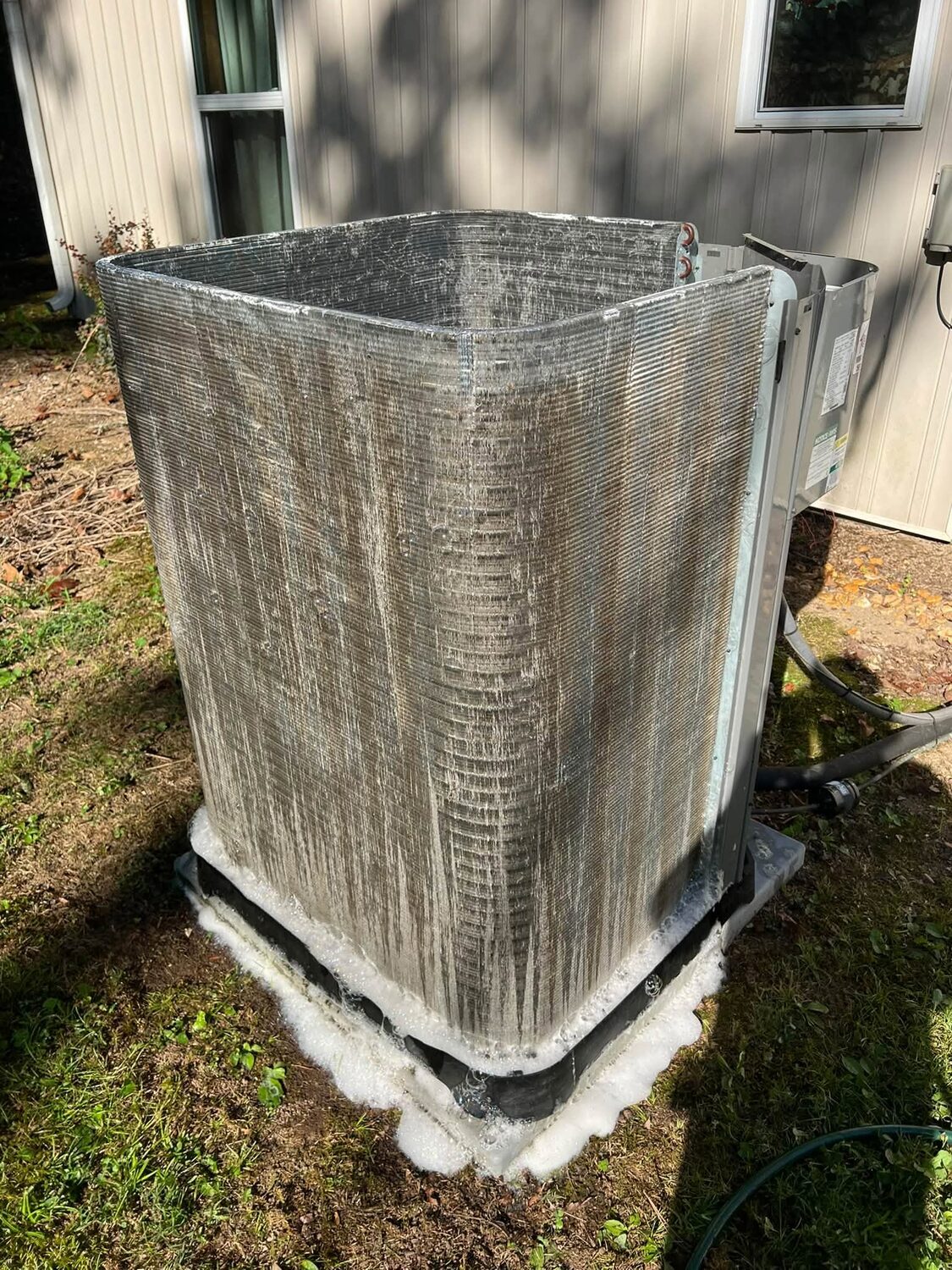 Applying coil cleaner to a dirty AC condenser