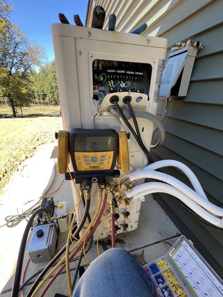 Mini-split condenser installed on the side of a home
