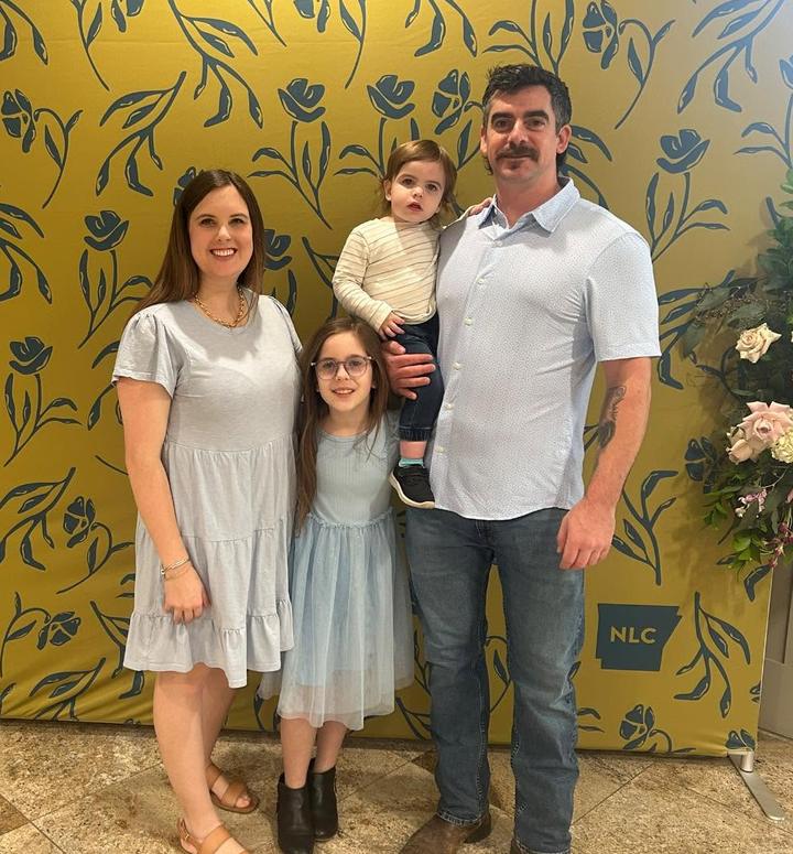 Tyler Whitfield, owner of Elite Air Service, with his wife and their two children